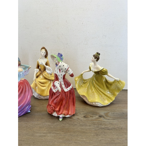 374 - Five Royal Doulton figurines, Pretty Ladies Autumn Breeze - HN 4716, Christmas Morn - HN 1992, Lynne... 