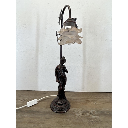 601 - A bronzed resin figural table lamp with artist's signature to base