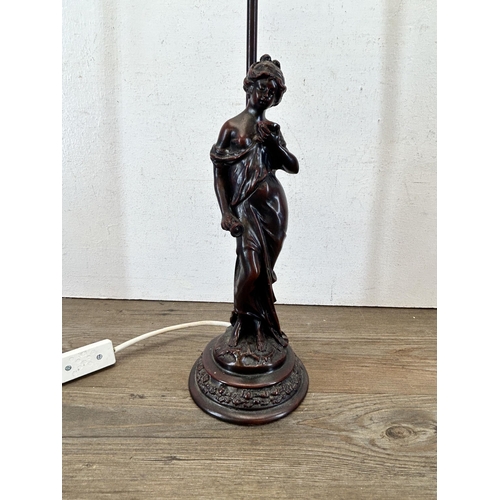 601 - A bronzed resin figural table lamp with artist's signature to base