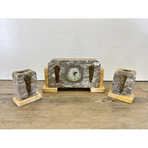 605 - An Art Deco marble and brass mantel clock with pair of matching garnitures