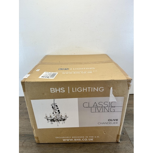 610 - A boxed BHS Lighting brass effect chandelier