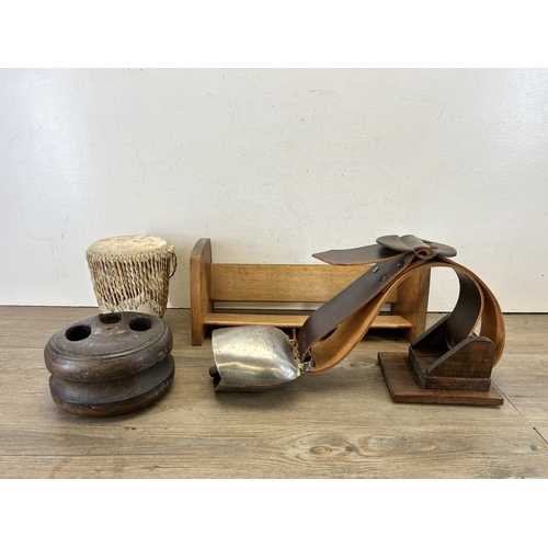 611 - Four items, mid 20th century teak free standing bookcase, African cowskin bongo, cow bell and antiqu... 