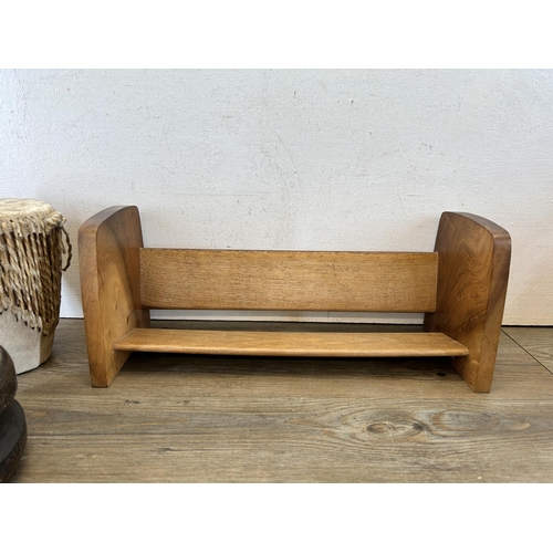 611 - Four items, mid 20th century teak free standing bookcase, African cowskin bongo, cow bell and antiqu... 