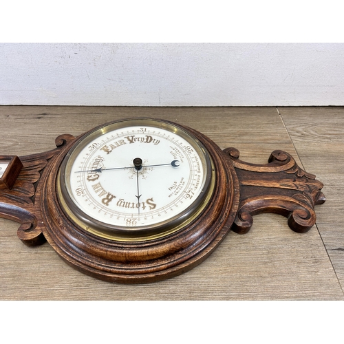 621 - A 19th century carved oak aneroid barometer - approx. 88cm high