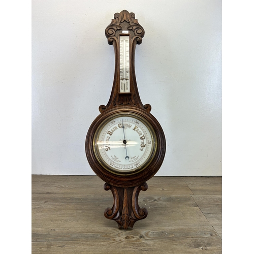 621 - A 19th century carved oak aneroid barometer - approx. 88cm high