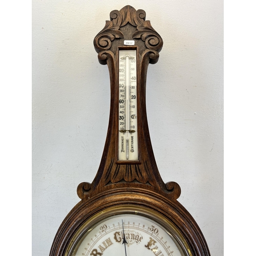 621 - A 19th century carved oak aneroid barometer - approx. 88cm high