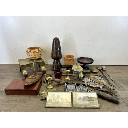 634 - A collection of items to include Victorian brass miniature footman/trivet stand, treenware, Estyma m... 