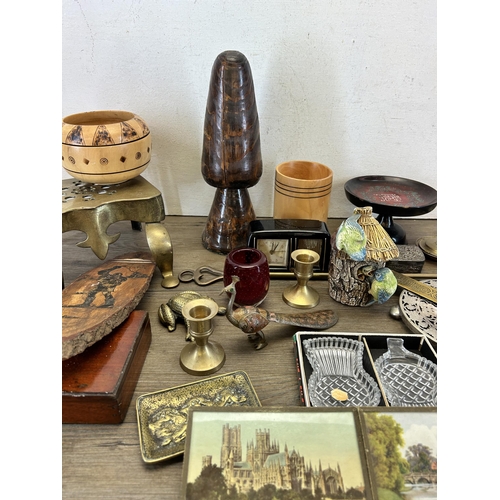 634 - A collection of items to include Victorian brass miniature footman/trivet stand, treenware, Estyma m... 