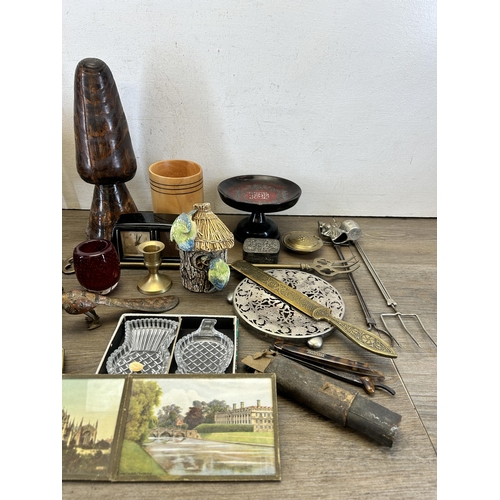 634 - A collection of items to include Victorian brass miniature footman/trivet stand, treenware, Estyma m... 