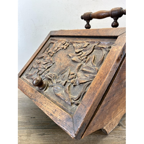 638 - A late 19th/early 20th century carved oak coal scuttle - approx. 48cm high x 36cm wide x 42cm deep