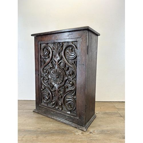 639 - A Georgian heavily carved oak spice cabinet - approx. 56m high x 43cm wide x 19cm deep