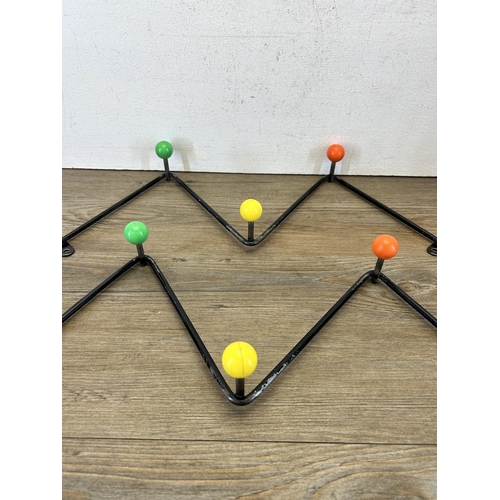 650 - A pair of mid 20th century black metal and multicoloured plastic Atomic/Sputnik coat hooks - approx.... 