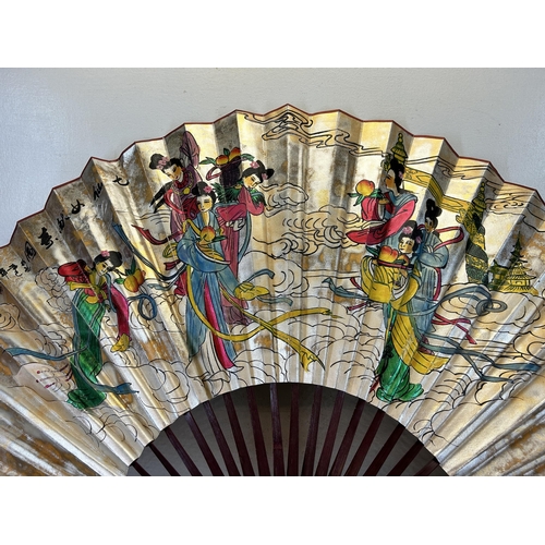 654 - An Oriental hand painted fan - approx. 136cm wide