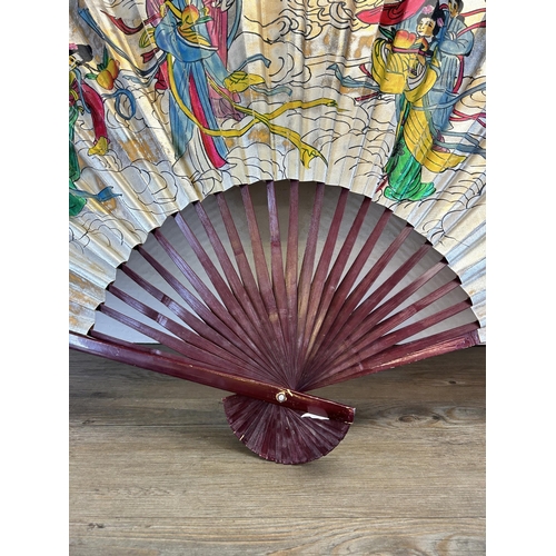 654 - An Oriental hand painted fan - approx. 136cm wide