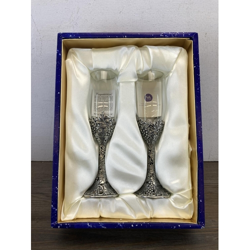 414A - A boxed pair of Royal Selangor champagne flutes with pewter detailing