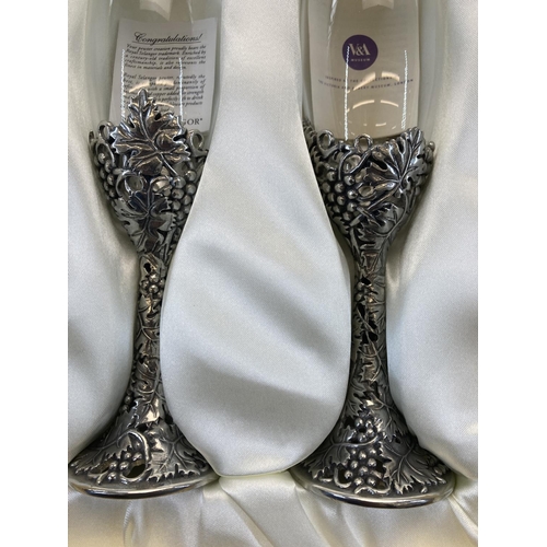 414A - A boxed pair of Royal Selangor champagne flutes with pewter detailing