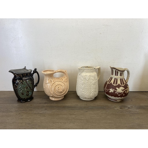 417 - Twelve 19th century and later ceramic jugs to include Art Deco Burleigh Ware parrot, Victorian Josep... 