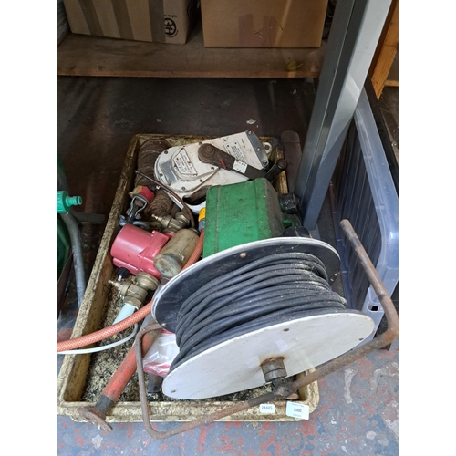 A collection of tools and garden items to include two hose reels, boxed ...