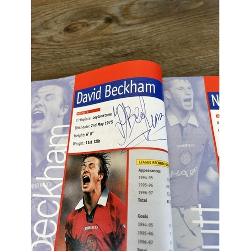 572 - A collection of 1990s Manchester United official programmes together with a signed official year boo... 