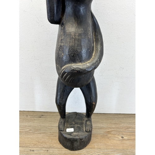 279 - A Maori carved hardwood statue - approx. 62cm high