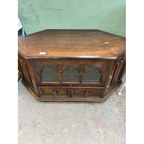 139 - A carved oak corner TV stand