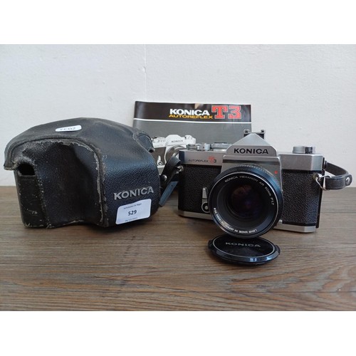 529 - A cased 1970s Konica Autoreflex T3 35mm SLR camera fitted with Hexanon AR F1.7 50mm lens with instru... 