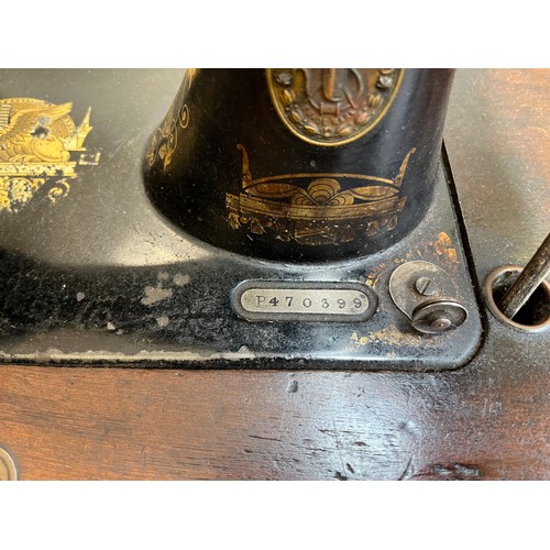 30 - A late Victorian Singer mahogany and cast iron treadle sewing machine, dated 1901 - serial no. P4703... 