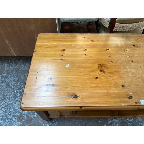 97 - A pine rectangular four drawer coffee table - approx. 53cm high x 58cm wide x 110cm long