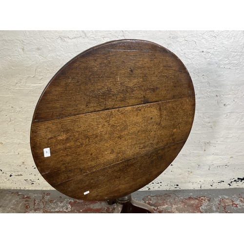 104 - A George III oak circular tilt top tripod occasional table - approx. 69cm high x 78cm diameter