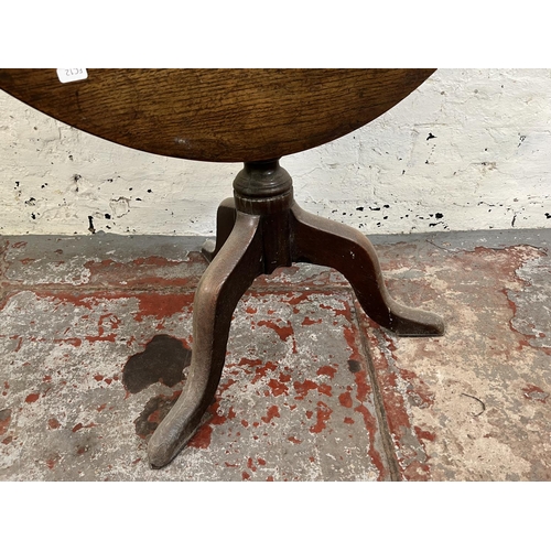 104 - A George III oak circular tilt top tripod occasional table - approx. 69cm high x 78cm diameter