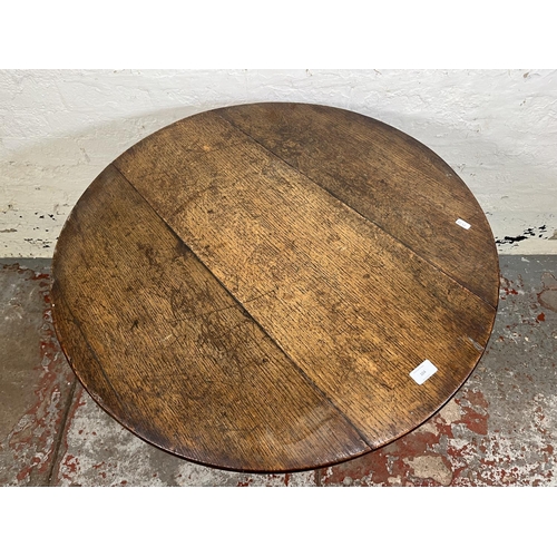 104 - A George III oak circular tilt top tripod occasional table - approx. 69cm high x 78cm diameter