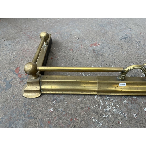 107 - A late 19th/early 20th century brass fire fender - approx. 120cm wide