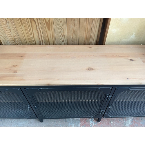 108 - An IKEA FJÄLLBO pine and black metal TV bench - approx. 55cm high x 149cm wide x 36cm deep