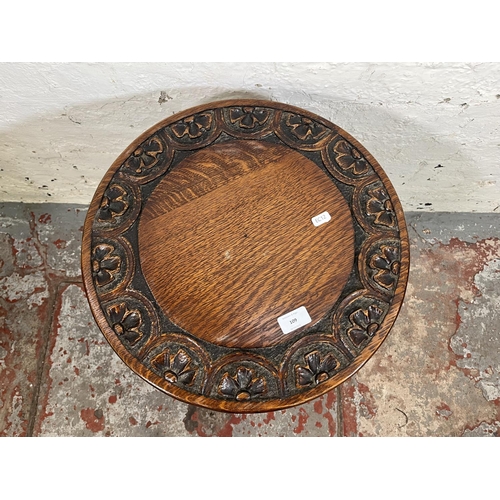 109 - A 17th century style carved oak circular pedestal side table - approx. 53cm high x 43cm diameter