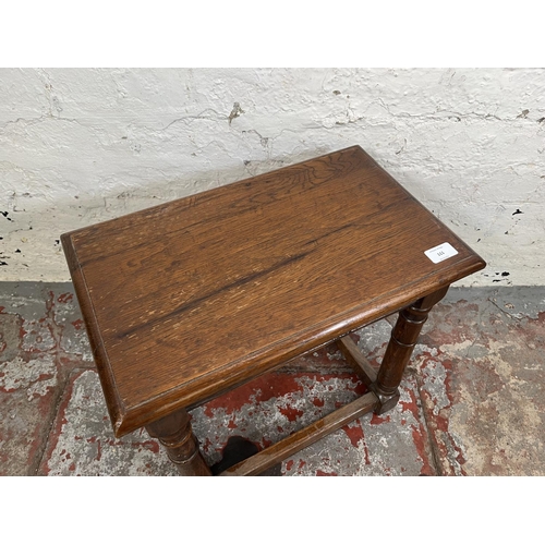 111 - A 17th century style oak joint side table with turned supports - approx. 44cm high x 46cm wide x 28c... 