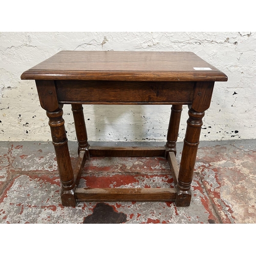 111 - A 17th century style oak joint side table with turned supports - approx. 44cm high x 46cm wide x 28c... 