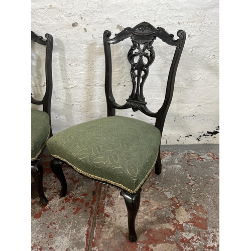 115 - A pair of late 19th/early 20th century carved mahogany and green fabric upholstered bedroom chairs