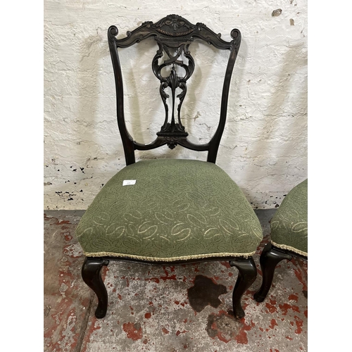 115 - A pair of late 19th/early 20th century carved mahogany and green fabric upholstered bedroom chairs