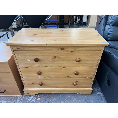 119 - Three pieces of furniture, two beech effect bedside chests of drawers and one pine effect chest of d... 