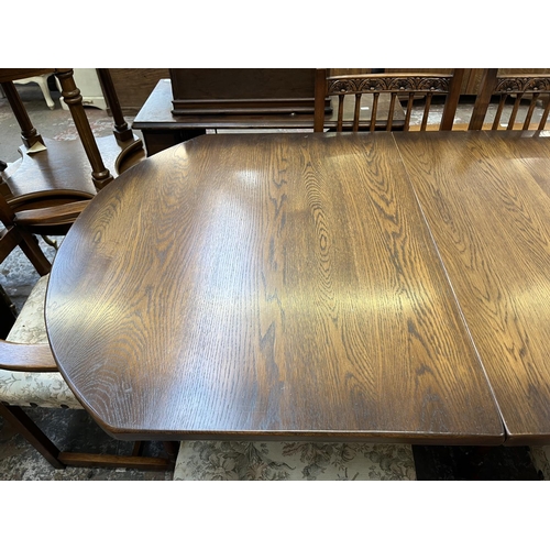 12 - A 17th century style carved oak extending dining table and six chairs - approx. 77cm high x 93cm wid... 