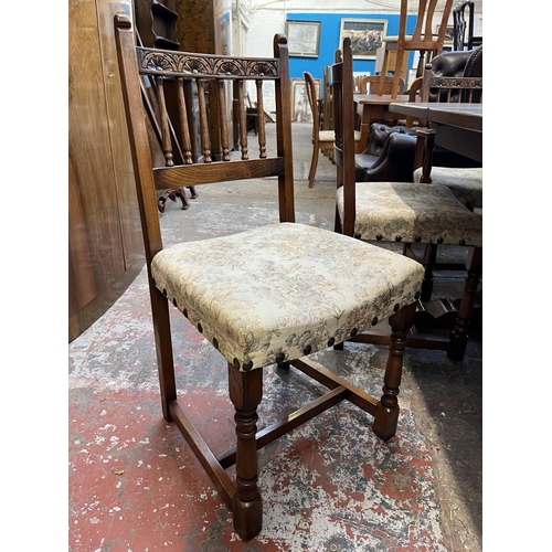 12 - A 17th century style carved oak extending dining table and six chairs - approx. 77cm high x 93cm wid... 