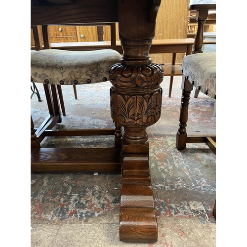 12 - A 17th century style carved oak extending dining table and six chairs - approx. 77cm high x 93cm wid... 