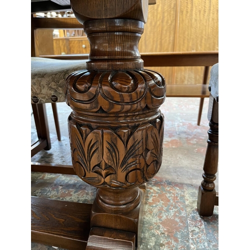 12 - A 17th century style carved oak extending dining table and six chairs - approx. 77cm high x 93cm wid... 