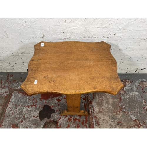 120 - A mid 20th century oak serpentine tilt top side table - approx. 77cm high when tilted x 43cm wide x ... 