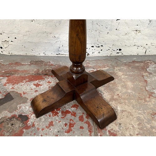 16 - A 17th century style oak circular pedestal side table - approx. 56cm high x 50cm wide