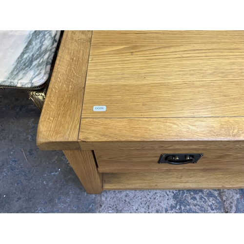 26 - A modern solid oak rectangular two drawer coffee table - approx. 50cm high x 65cm wide x 105cm long