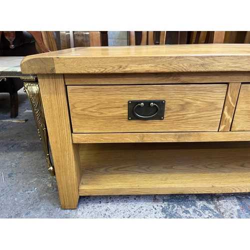 26 - A modern solid oak rectangular two drawer coffee table - approx. 50cm high x 65cm wide x 105cm long