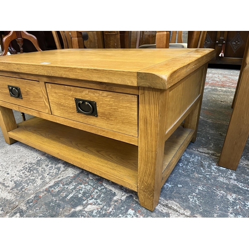 26 - A modern solid oak rectangular two drawer coffee table - approx. 50cm high x 65cm wide x 105cm long