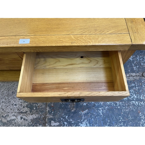 26 - A modern solid oak rectangular two drawer coffee table - approx. 50cm high x 65cm wide x 105cm long