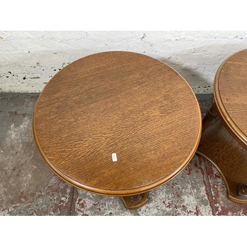 29 - A pair of oak circular two tier side tables - approx. 51cm high x 60cm diameter